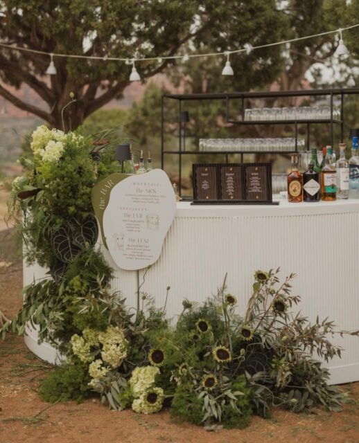 The Bar Is More Than a Place to Grab a Drink. It’s Part of the Design. 🥂

Gone are the days of a simple bar menu on an easel. Today’s wedding bars are thoughtfully styled experiences—layered with lush florals, sculptural arrangements, custom signage, statement lamps, textured linens, fruit accents, and curated décor that reflects the couple’s personality.

Whether you’re drawn to romantic garden-inspired blooms, playful citrus palettes, modern minimalism, or timeless elegance, your bar can become one of the most photographed moments of the reception.

Think beyond the cocktails:
• Signature drink menus with custom illustrations
• Oversized floral installations
• Designer bar fronts and statement textures
• Ambient lighting for an elevated evening glow
• Personalized details that tell your story
• Color palettes that seamlessly tie into your overall wedding aesthetic

Your guests may come for the cocktails—but they’ll remember the experience.

✨ Save this for your wedding inspiration and don’t overlook one of the most impactful design moments of the day.

#CaboBride #WeddingBar #WeddingInspiration #BarStyling #WeddingDesign